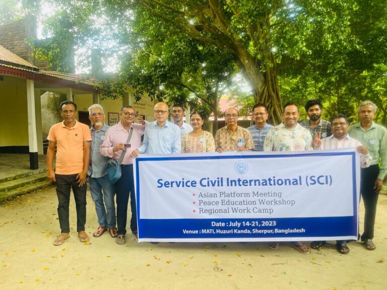 The group of delegates posing with an SCI banner