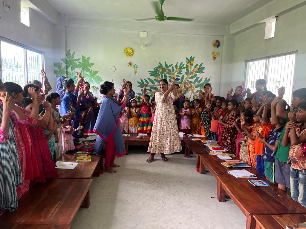 volunteers and children dancing