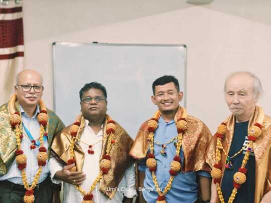 APM closing ceremony session, the photo depicts 4 man posing for a group photo, they seem to be wearing a ceremony necklace